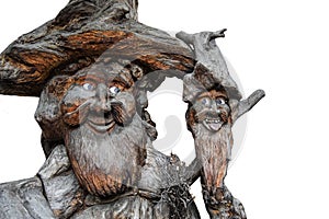 Two old gnomes, guardians of the woods, sculpted in a trunk