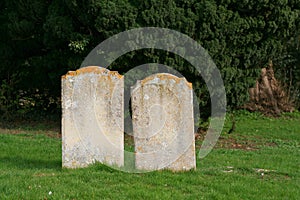 Two old gravestones close together.