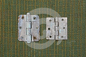 Two old gray metal door hinges