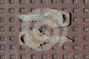 two old gray metal keys in rust