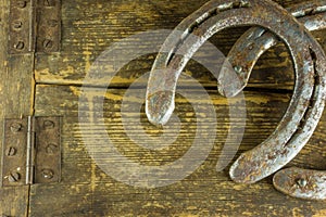 Two old horseshoes on a rustic wooden