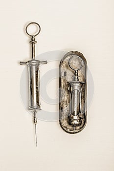 Two Old injection and a metal box photo