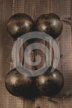 Two old iron dumbbell on a wooden dark background/two old iron d