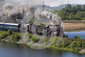 Two old locomotives of L series pull the `Ruskeala Express` tourist retro train