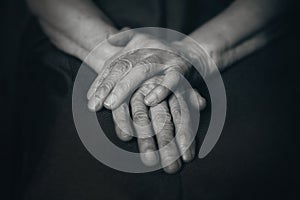 Two old man's hands on knees