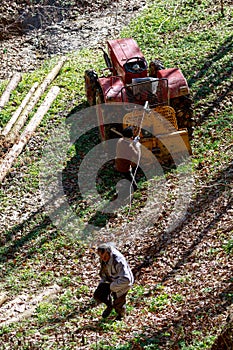 two old man working with a tractor
