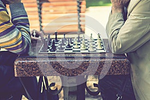 Two old men playing chess. Active retired people, old friends and free time. Active retired people old friends and free