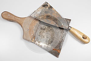 Two old painter`s spatula and use marks with wooden handle on white background