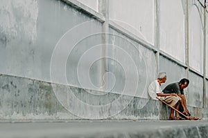 two old people talking casually on the roadside in the afternoon