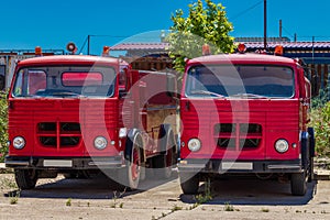 Two old red fire trucks