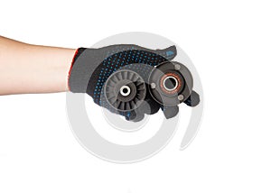 Two old rollers of the timing system from the car in the hand of a car mechanic on a white background, isolate. Close-up