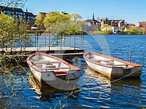 Two old row boats moored on the lake