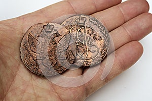 Two old Russian coins of the 18th century in the palm