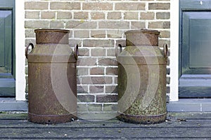 Two old rusted churns photo