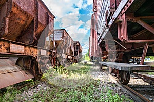 Two old abandoned cargo train sets standing on some old tracks