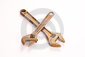 Two old rusty adjustable wrench crossed over each other