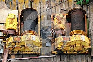 Two old rusty winches with steel rope