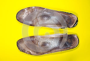 Two old, shabby inner dirty insoles of shoes. Worn out things