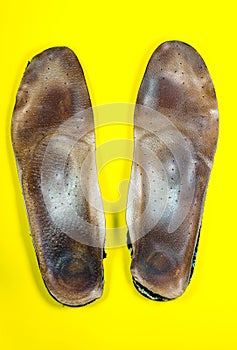 Two old, shabby inner dirty insoles of shoes. Worn out things