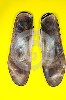 Two old, shabby inner dirty insoles of shoes. Worn out things