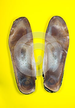 Two old, shabby inner dirty insoles of shoes. Worn out things