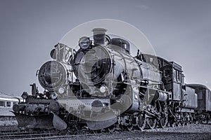 Two old steam locomotives standing side by side