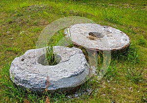 Two old stone millstone