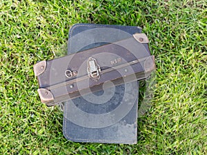 Two old suitcase on grass
