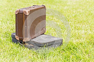 Two old suitcase on grass