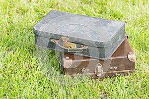 Two old suitcase on grass