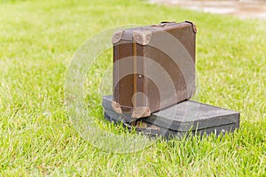 Two old suitcase on grass