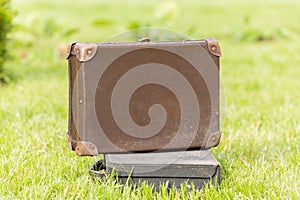 Two old suitcase on grass