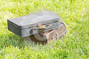 Two old suitcase on grass