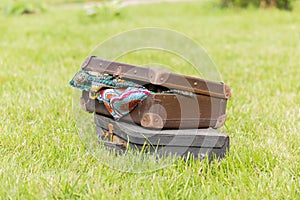 Two old suitcase on grass