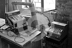 Two old-time cash register in abandoned shop, Black and white photo