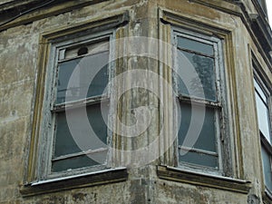 Two old windows in ruined wall of some building