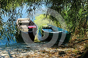 Two old wooden boats on the river bank. Travel, landscapes concept.