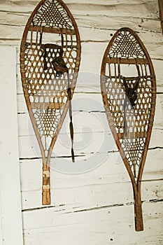 two old wooden snowshoes on wall