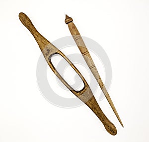 Two old wooden spindle for the manufacture of woolen threads on a white background