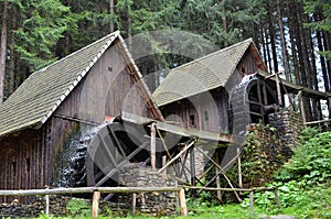 Two old wooden water mill with mill-wheel detail photo