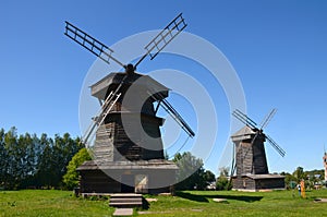 Two old wooden windmills in the museum of wooden architecture on a sunny summer day in the city of Suzdal, Russia