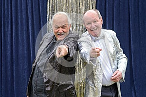 Two older men giving a lively stage performance