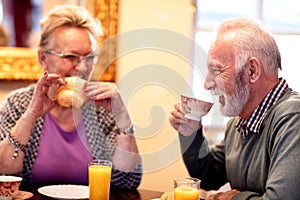 Two older people talking and enjoying in delicious foods