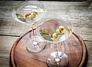 Two olive martini cocktails
