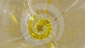 Two olives falls into olive oil in glass - slowmotion