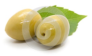 Two olives with leaf on white background
