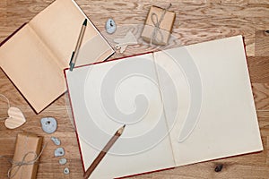 Two open books on the table. View from the top. Parcels or gifts associated with twine. The vintage style.