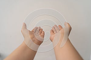 Two open empty female hands with palms up, holding something, isolated on white background