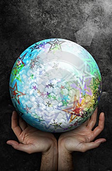 Two open hands up facing a large sphere with colorful abstract surface with stars.