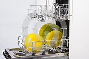 Two open loading nets with clean plates, cups and glasses, after washing in an economical dishwasher